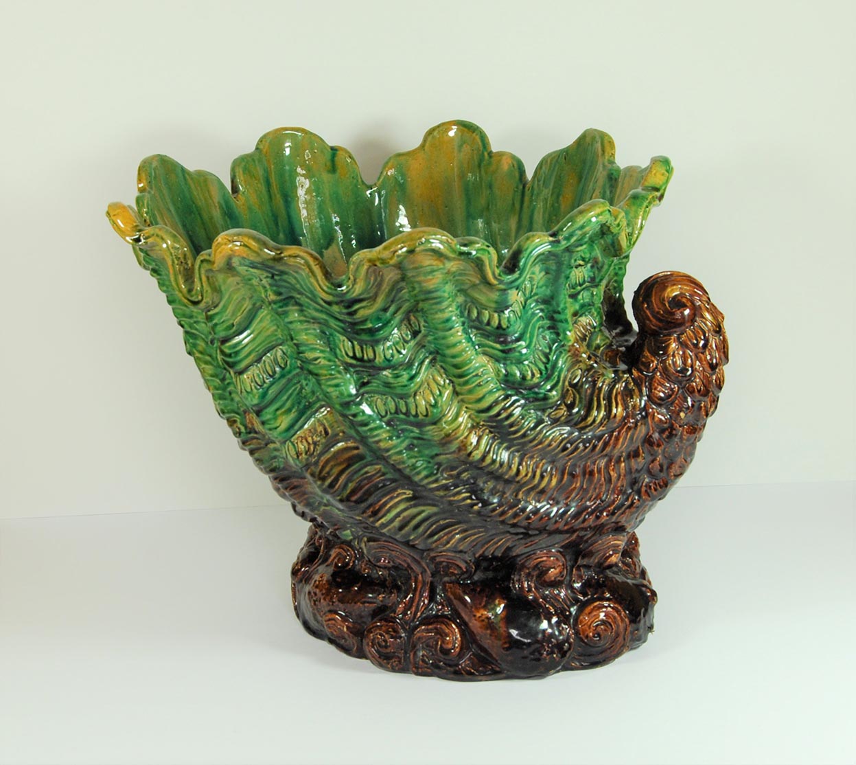 Image of  vase green and brown colours with ripples.  