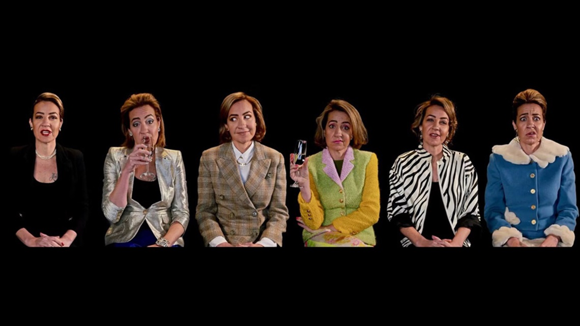 Six identical women sit facing the viewer. Each in different outfits and with different facial expressions. 