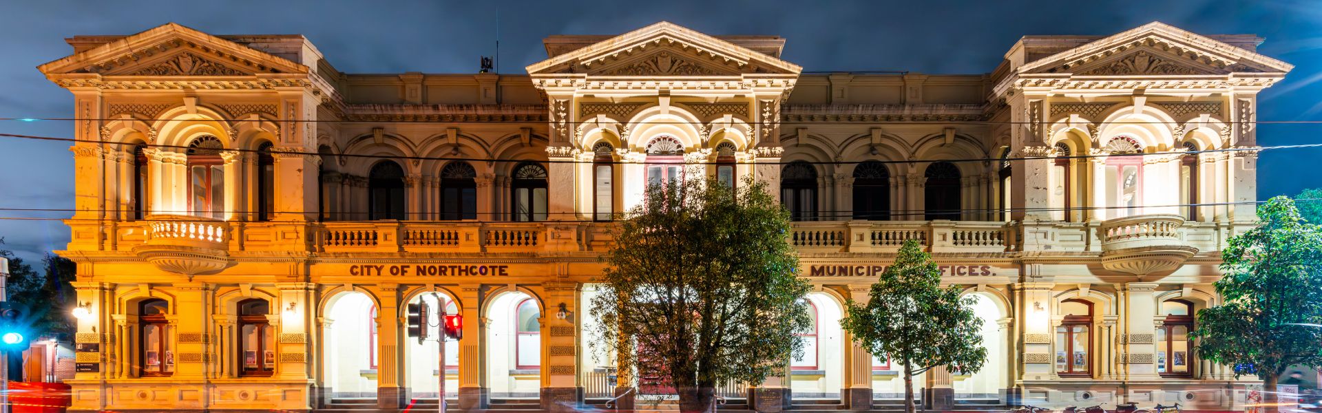 Afront view perspective of Northcote Town Hall Arts Centre lit up at night