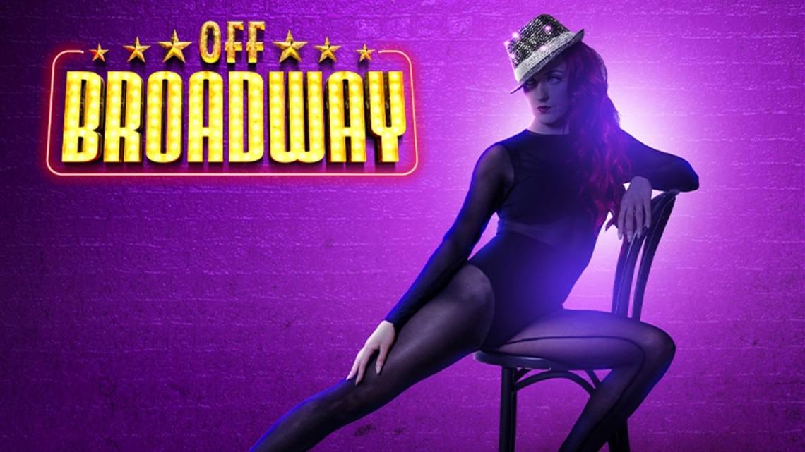 A cartoon image of a female dancer wearing a hat sitting in a chair with her right leg pointed outwards and left arm resting on the back of the chair.