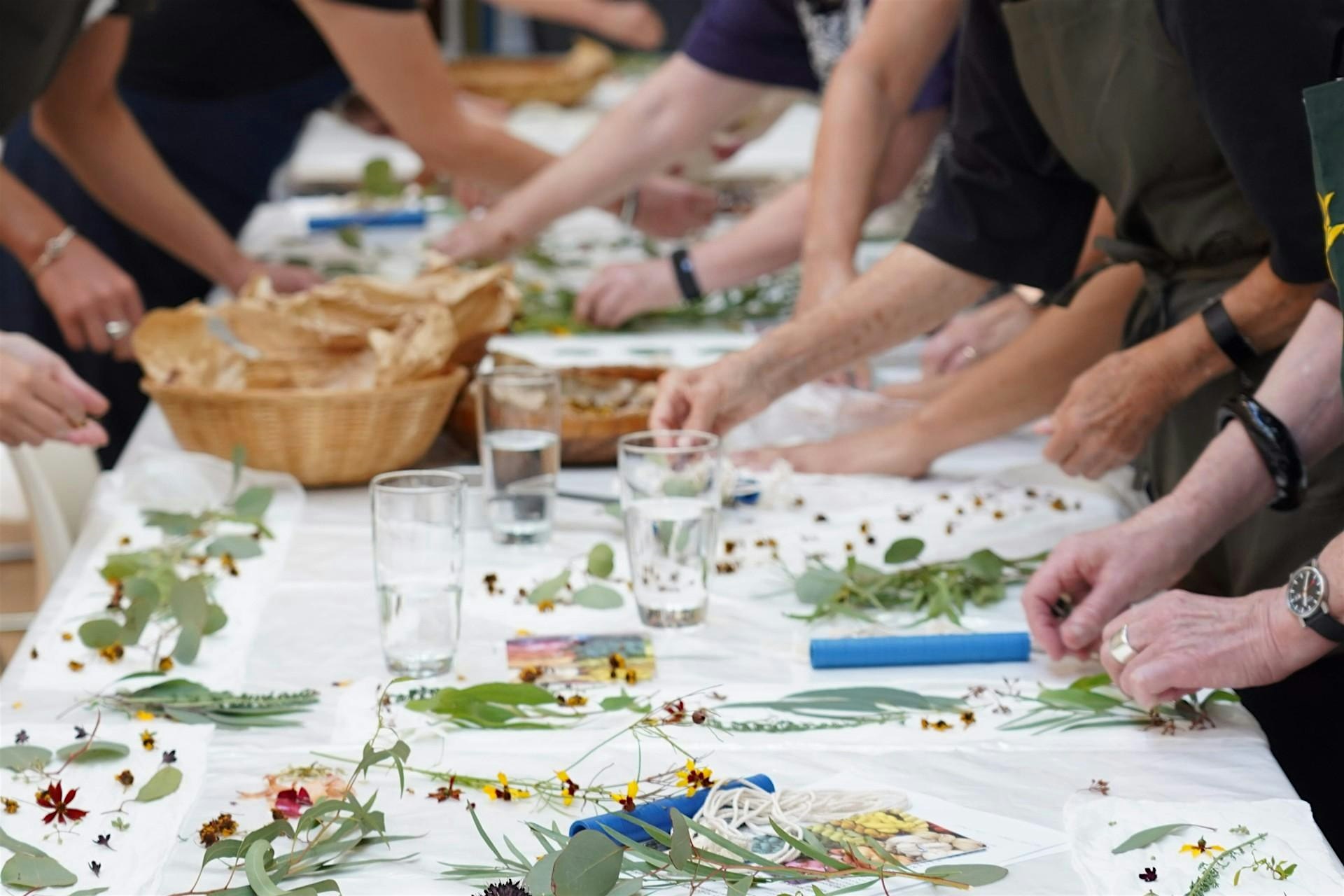 A table of flowers being used to create eco-prints