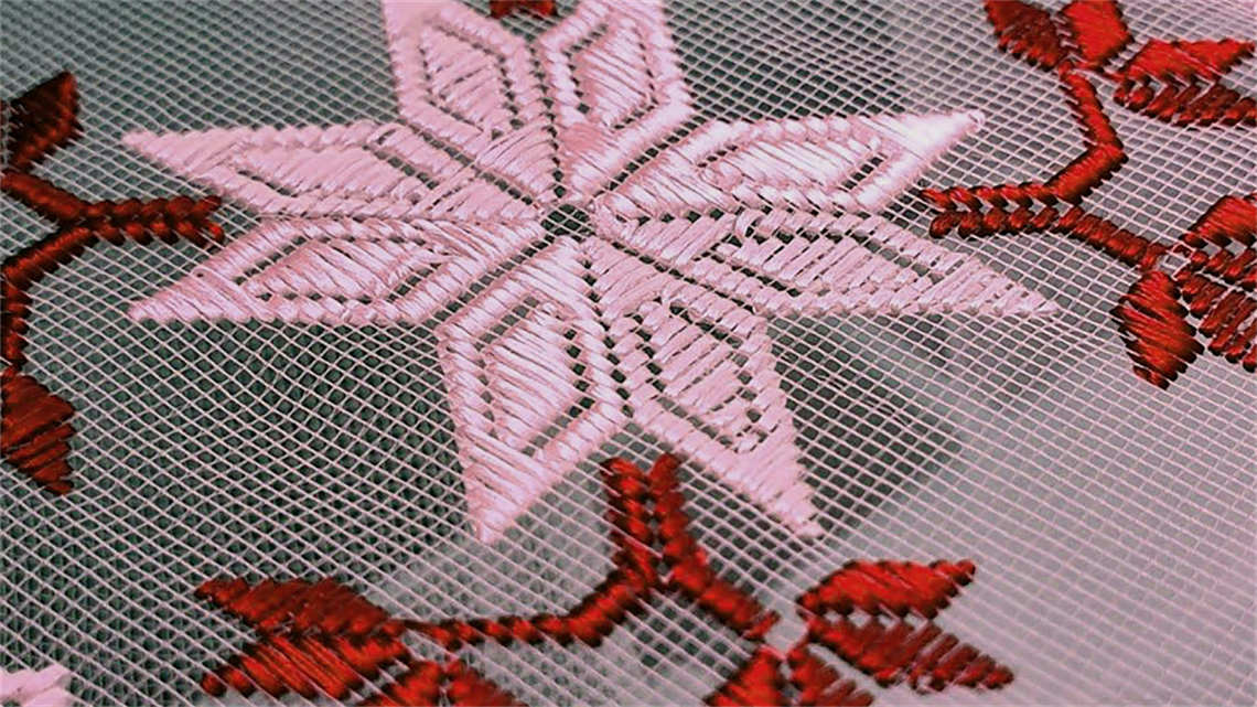 A pink and red floral embroidery
