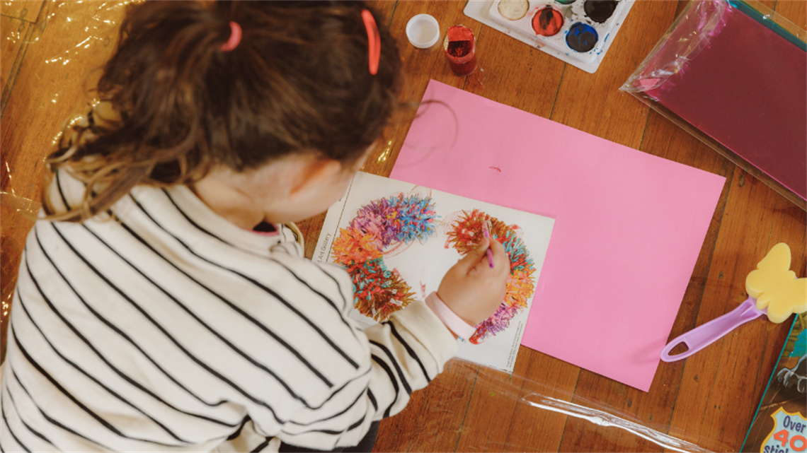 A child works on an arts project 