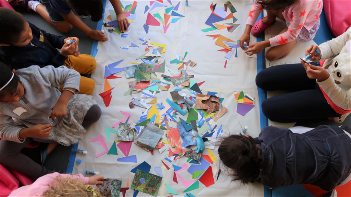 A group of children work on a collage activity